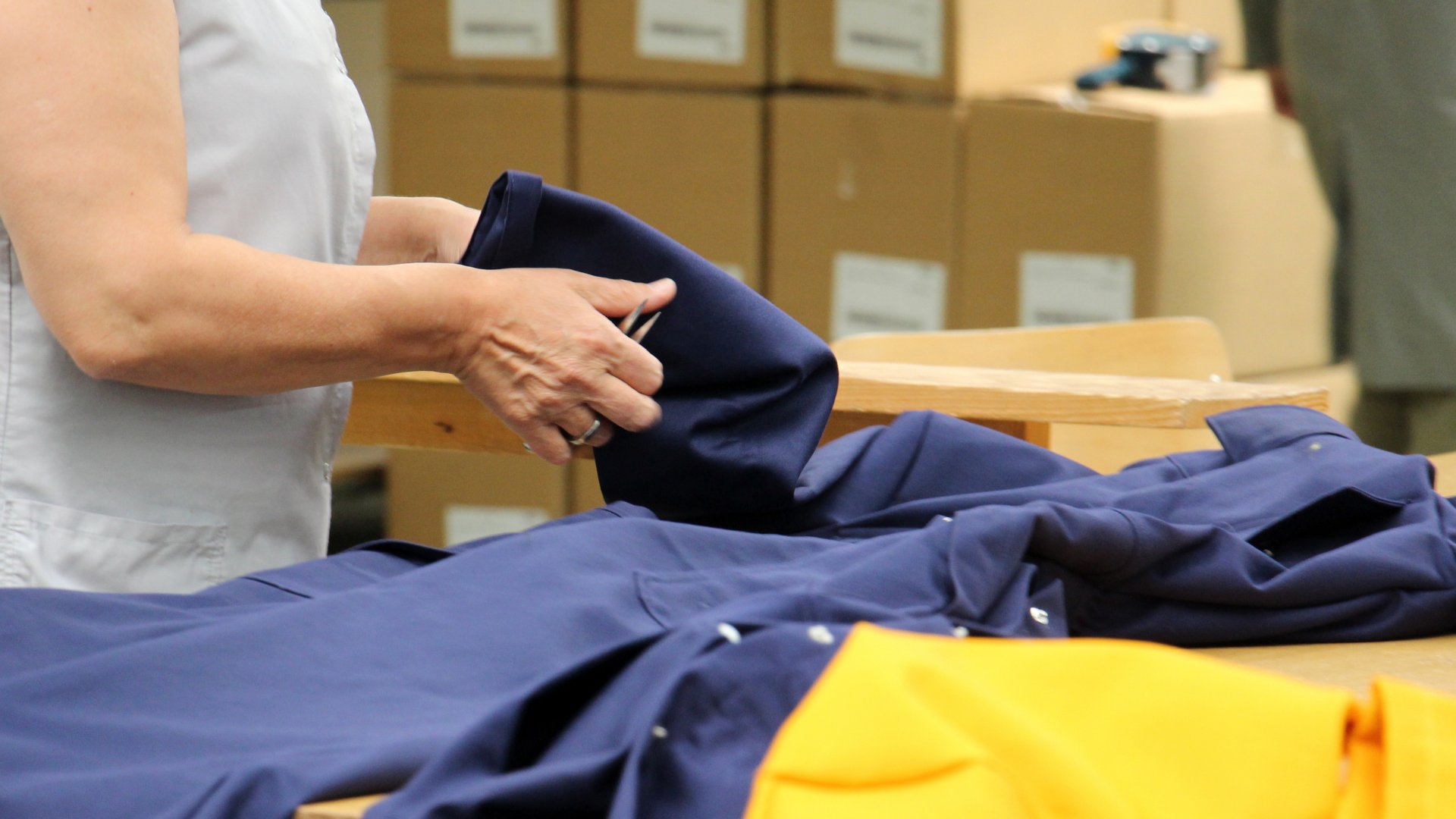 Team member refolding returned apparel in a Fillogic hub